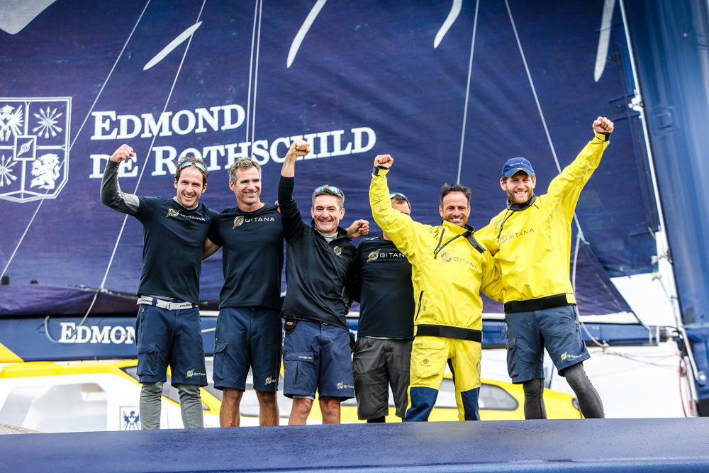 The crew of Maxi Edmond de Rothschild celebrate their record-breaking race today © Paul Wyeth/www.pwpictures.com