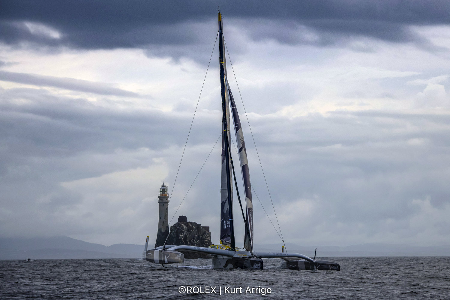 Maxi Edmond de Rothschild was first round the Fastnet Rock at 0800 BST in the Rolex Fastnet Race © Kurt Arrigo/Rolex