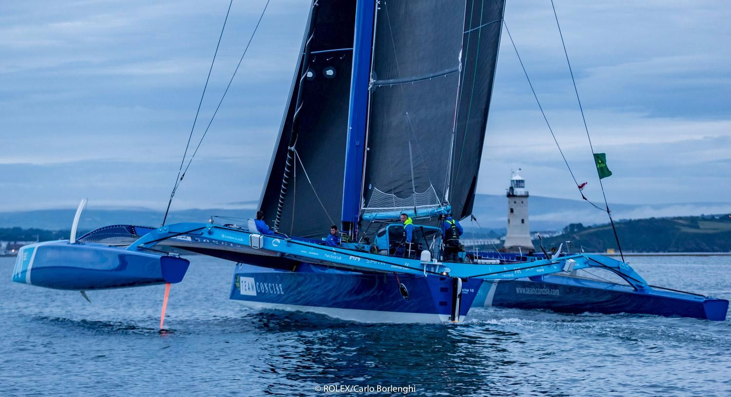 MOD70, Concise 10, cross the finish line of the Rolex Fastnet Race in Plymouth. Credit: ROLEX/Carlo Borlenghi