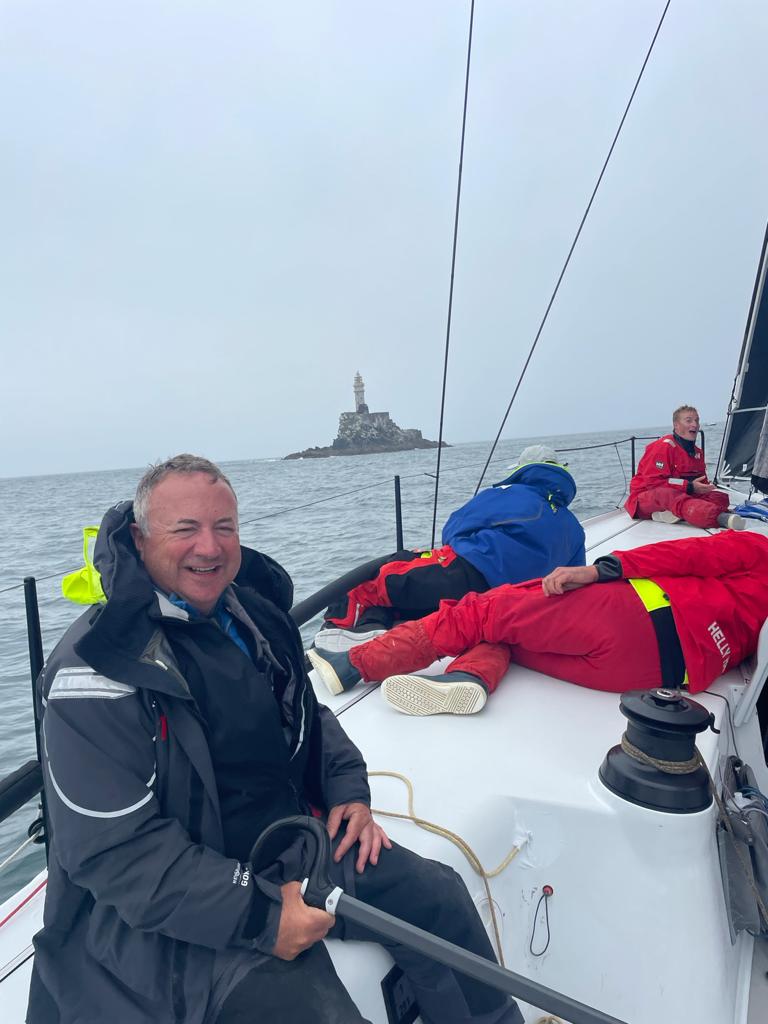 RORC Commodore, James Neville rounds the Fastnet Rock on his HH42