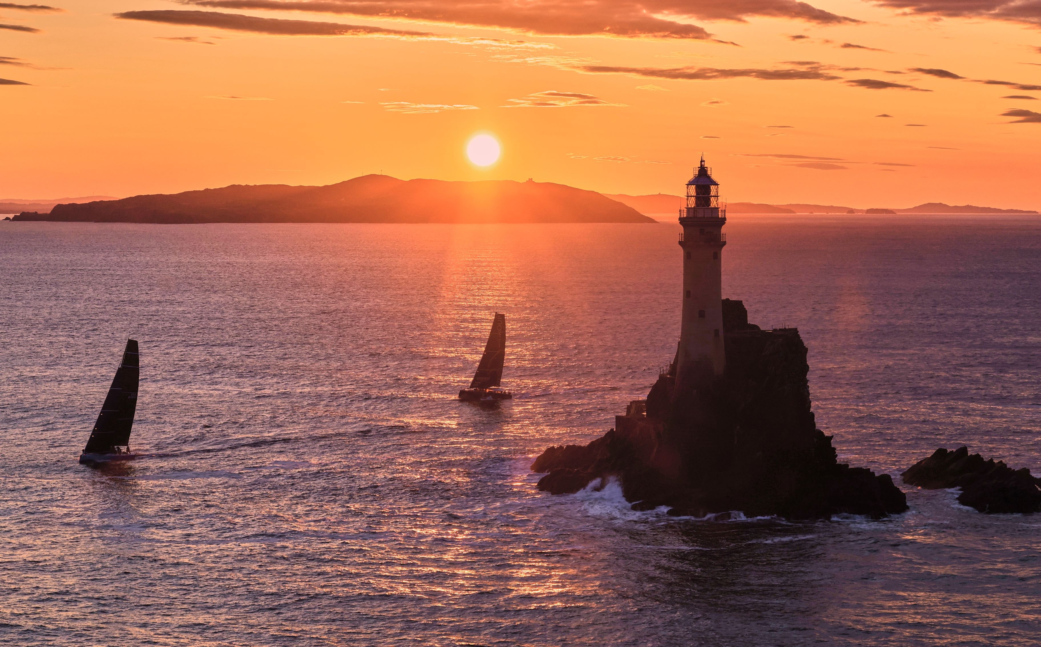 Warm sunrise as PAC 52 Warrior Won and ORC50 Lodigroup round the Fastnet Rock © ROLEX/Carlo Borlenghi